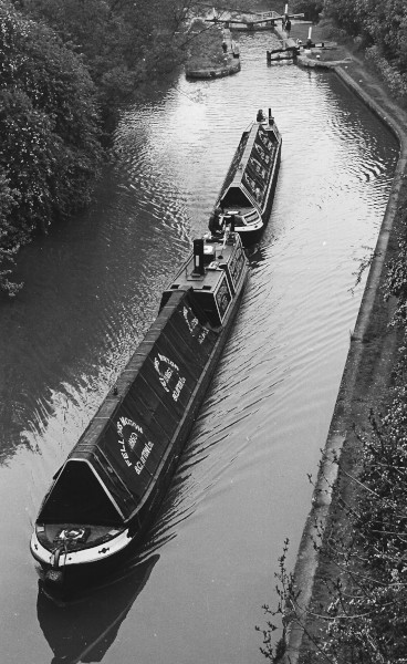 image Steam returns to the Grand Union Canal near Leamington Spa in May 1980. En route to the National Rally of Boats on the River Lea, the restored FMC steamer President leaves Radford Bottom Lock towing the preserved FMC horse boat Northwich. 