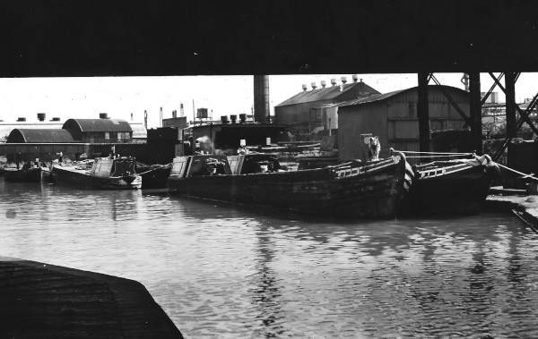 image B.C.N. Old Main Line 473ft level.  View of Thos. Clayton (Oldbury) Ltd boatyard taken looking towards Smethwick from underneath Stone Street Bridge.  Photo CP Weaver 1955